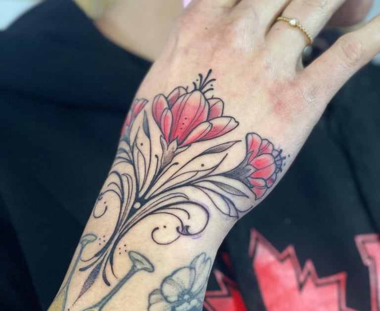 Ornamental flower Tattoo in the woman’s hand. 