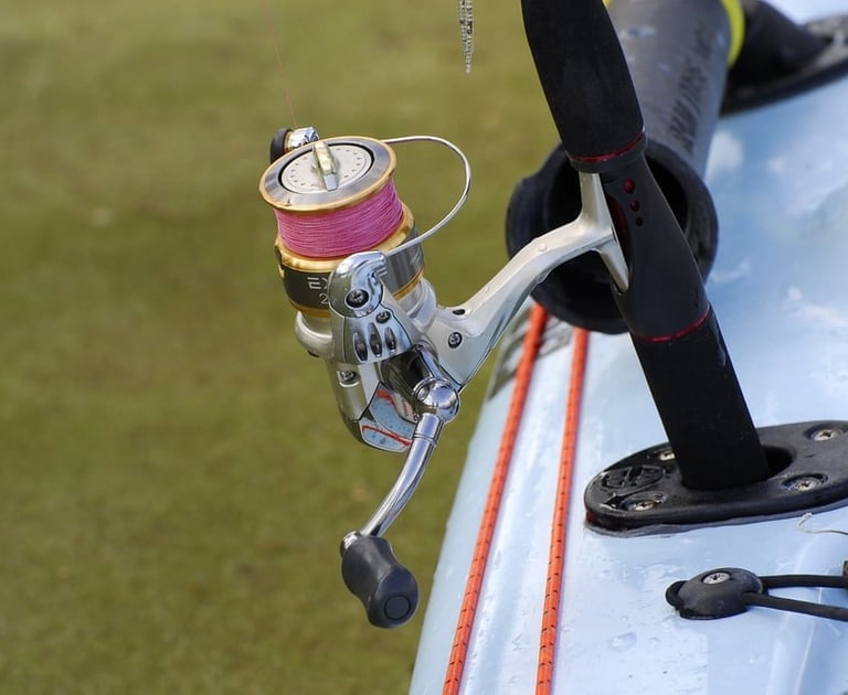 a fishing reel with pink fishing line