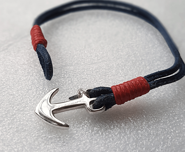 a bracelet bracelet with a silver anchor on a white background