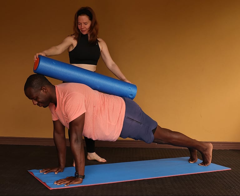 a man and woman doing pilates exercises on a mat