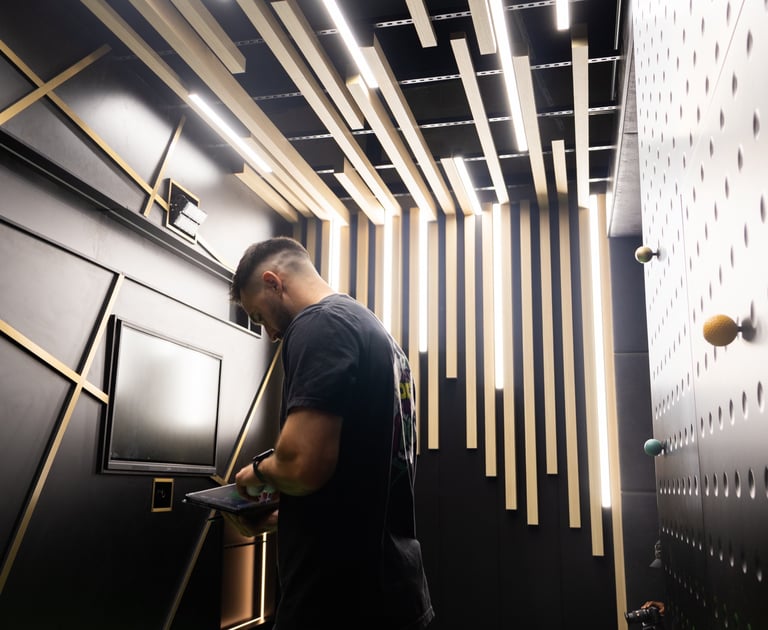 A team member of 1IRON indoor golf in the high tech bunker bay