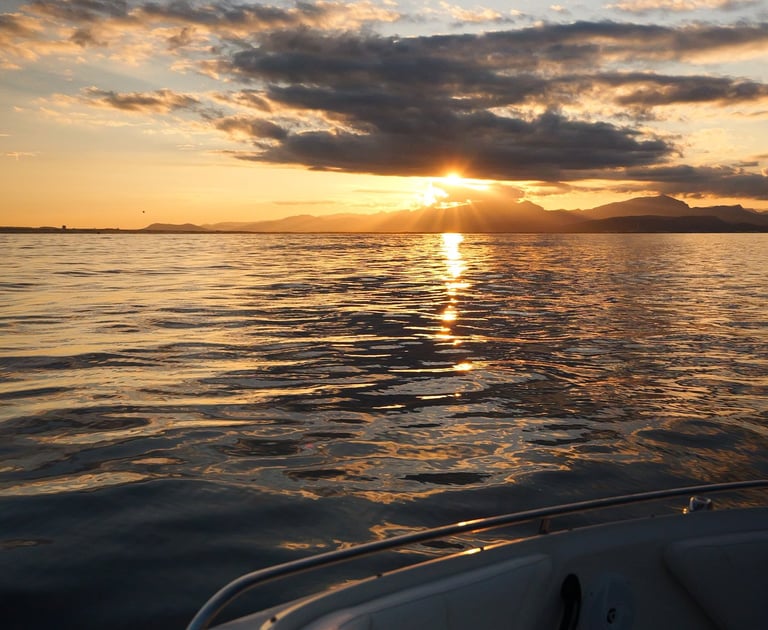 Sunset view from a boat in Alcudia Port during a Private Tour