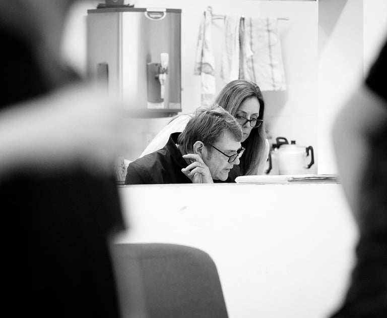 A man and woman reading something