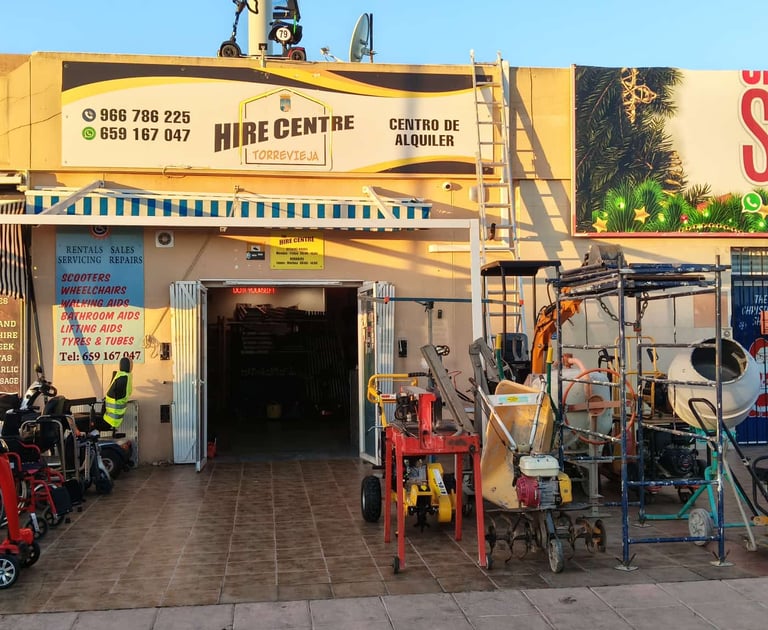 Torrevieja hire centre storefront displaying rental mobility scooters and construction equipment tools.