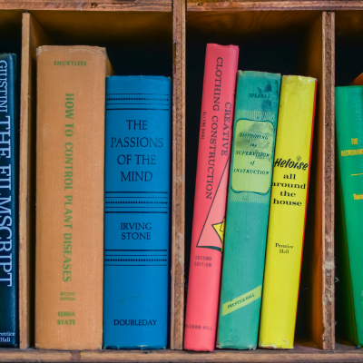 a collection of books on a shelf in a bookcase