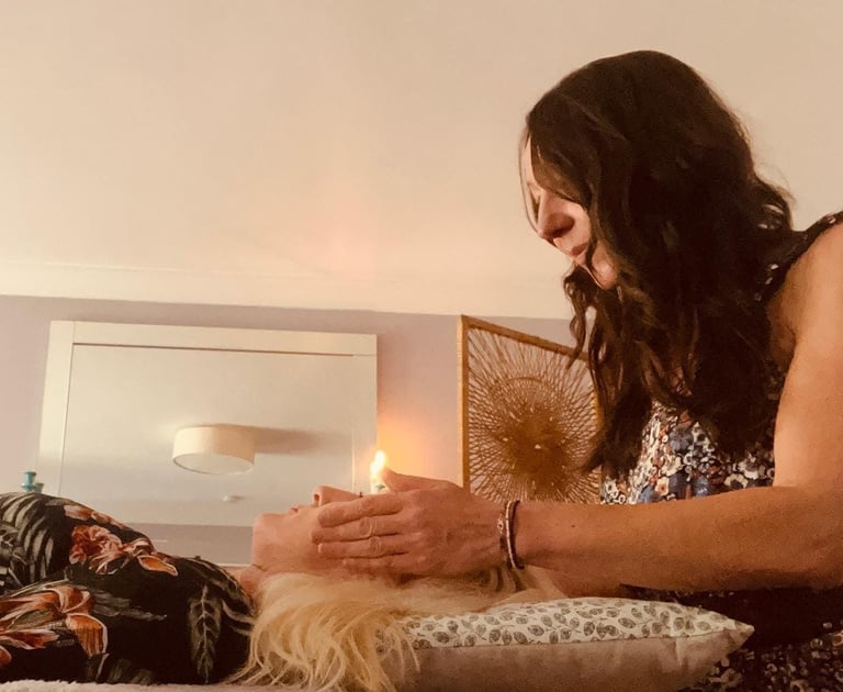 Liv giving reiki to a lady; her hands around her head