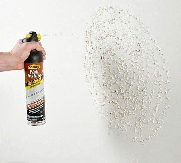 a person holding a spray canister of a spray canister