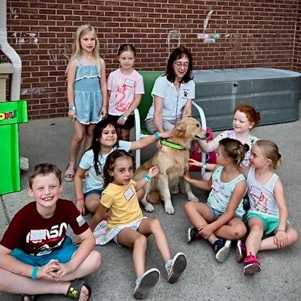 Kids visiting with Pet Partners Therapy Dog Team Ana and Lori.