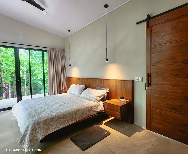 a bedroom with a bed and sliding glass doors
