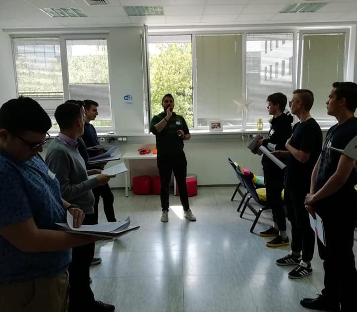 a man standing in a room with a microphone and a microphone