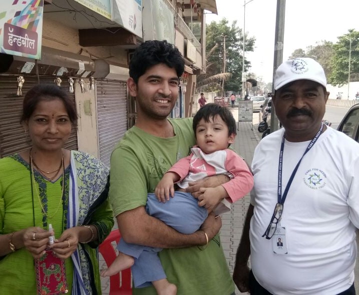 a woman and two men standing in front of a store