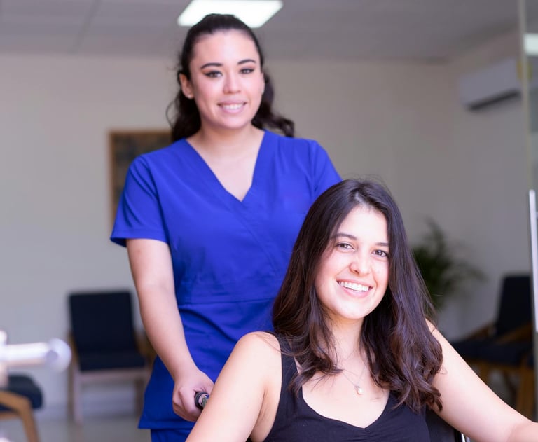 a woman in a wheelchair with a nurse