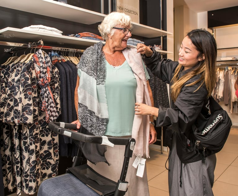 an elderly woman in a dress shirt and a stroller