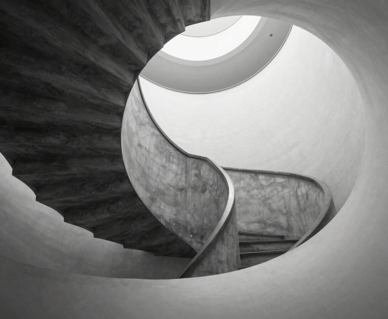 A minimalist black and white photograph of a spiral staircase, representing structure and continuous growth. High-end architectural photography.