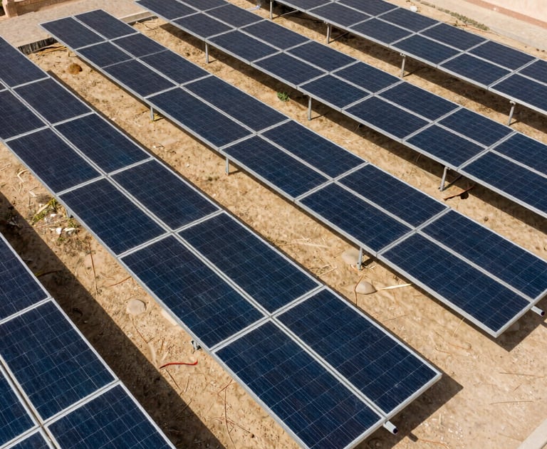 A bird's eye view of a neatly arranged residential solar system with battery storage. Professional, clean layout. Middle Eastern / Yemeni setting.