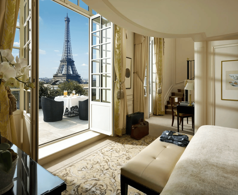 a luxury bedroom with a view of the eiffel tower