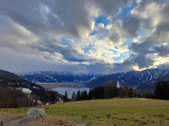 Scenic view of Lake Zell and snowy Alps during Zell am See Austria day trip.