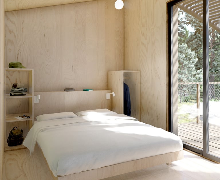 a bedroom with a bed and a wooden floor