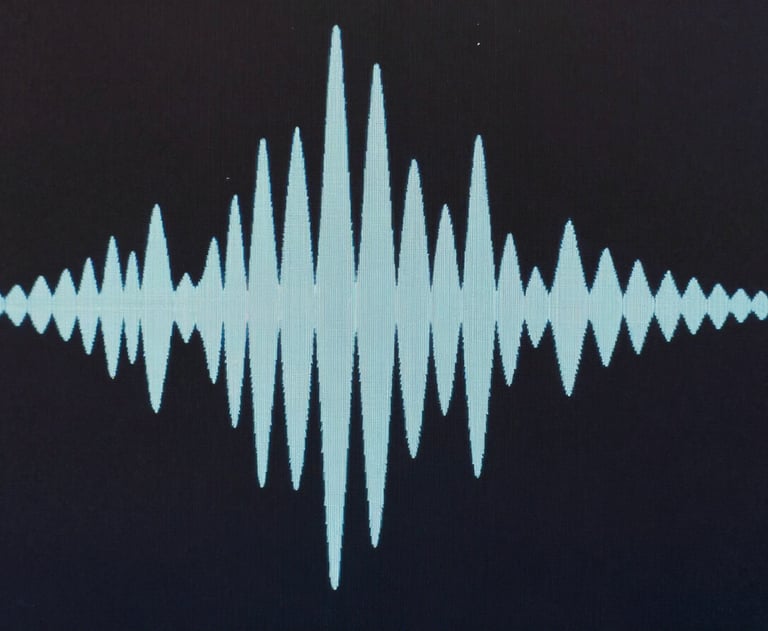 Abstract pattern of sound waves on a screen, minimalist and artistic, in colors of dark charcoal and pale blue.