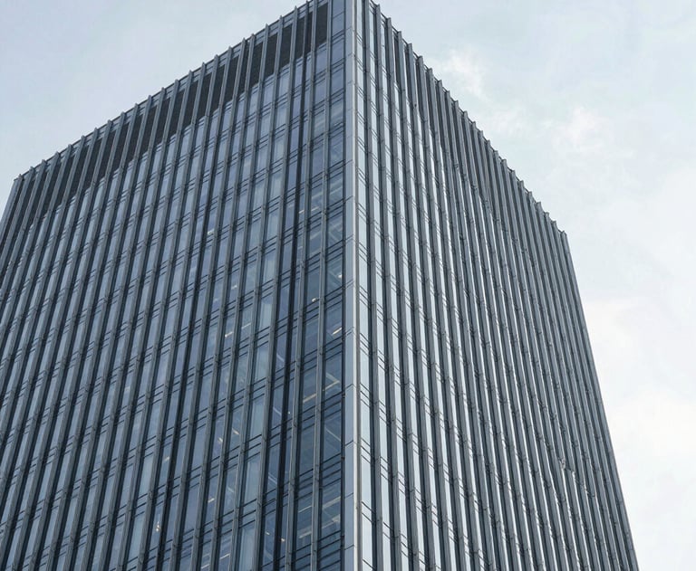 A minimalist photograph of an architectural detail of a modern skyscraper, showing clear glass and steel lines against a bright sky. The focus is on the upward trajectory and precision of the design.