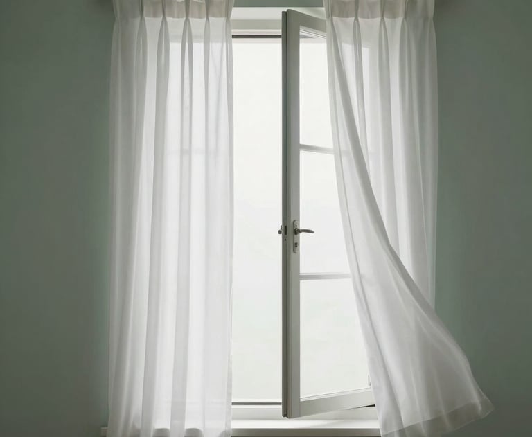 Minimalist shot of an open window with white curtains blowing slightly in the breeze. Soft, airy, and professional. Sage green and white palette.