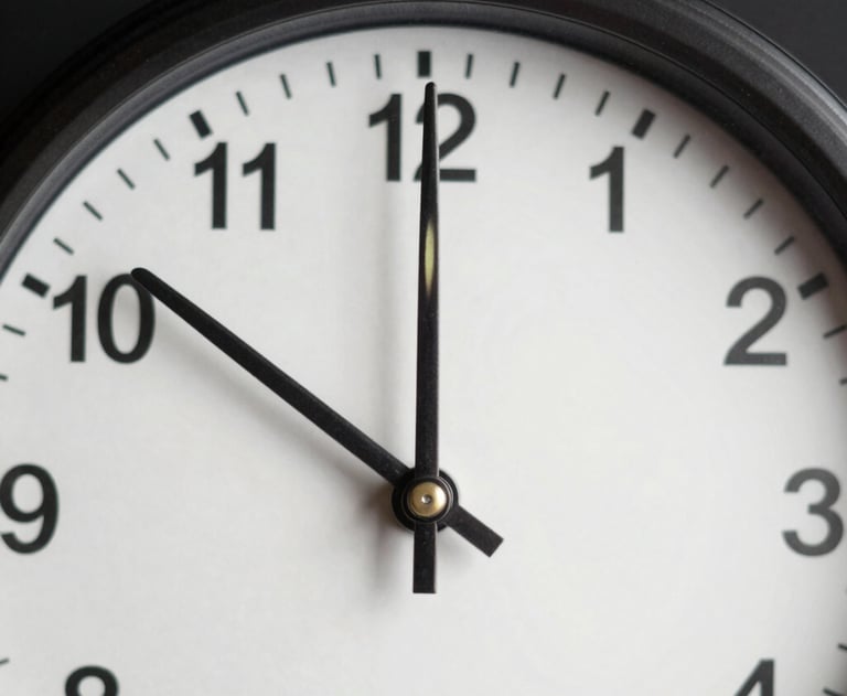 A close-up shot of an analog clock with a minimalist face and clean metal hands, set against a dark background. Symbolizing precision and time management.