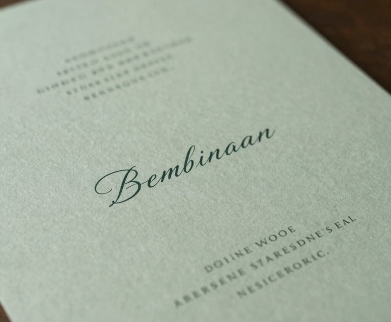 Minimalist photography of high-end wedding stationery featuring elegant typography and soft green colors, South American / Brazilian style.