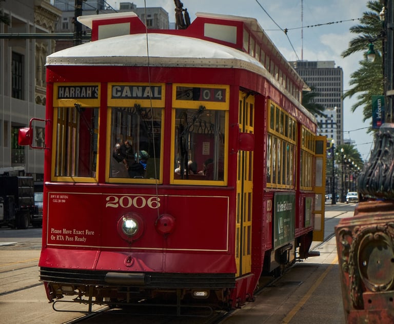 a red trolley car on a city street