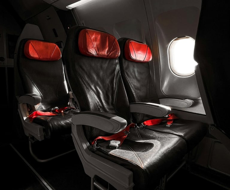 Airplane seats with red headrests