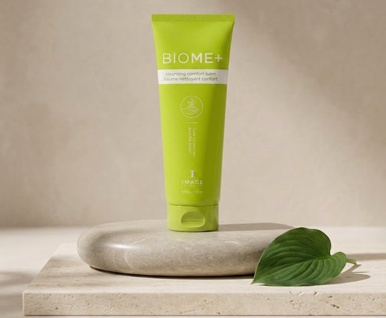 IMAGE BIOME+ Cleansing Comfort Balm on a stone pedestal with a leaf accent and neutral background.
