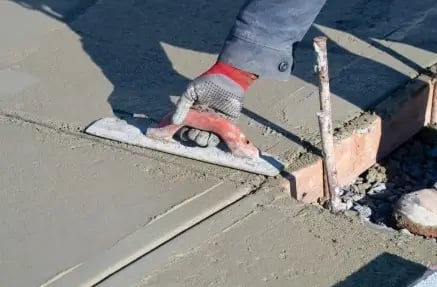 a person is using a cement blocker to make a concrete floor