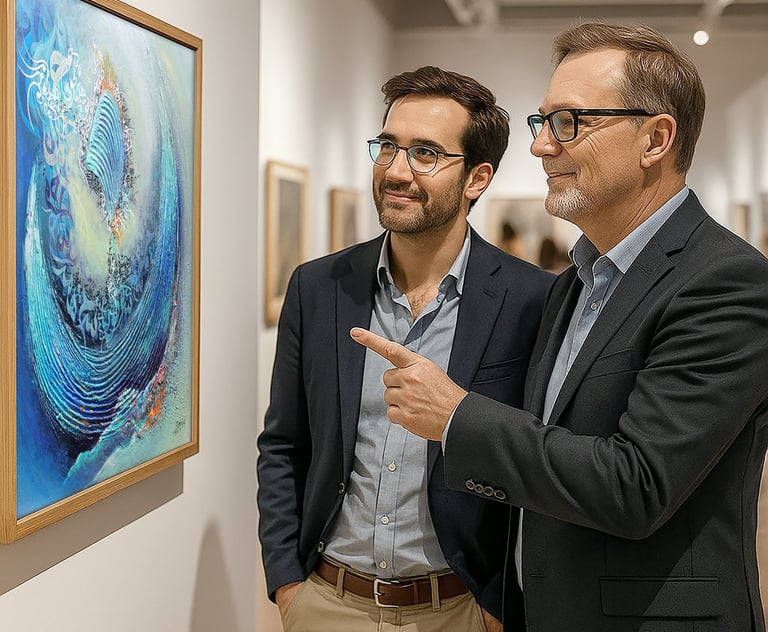 two men standing in front of a painting