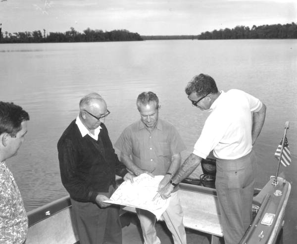 roy disney inspects map of Florida land on boat