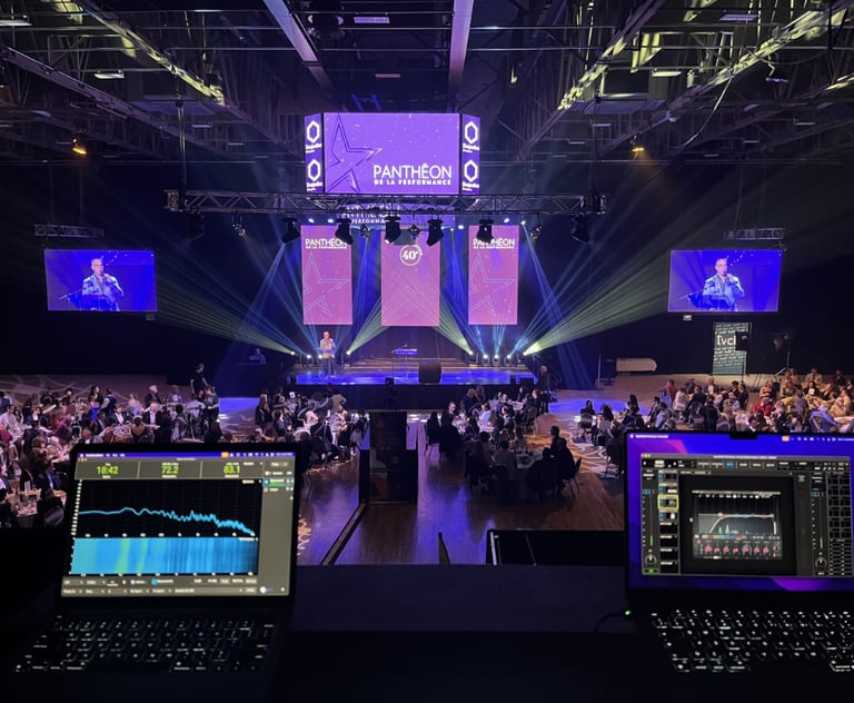 Professional live event production featuring laptops with audio monitoring software at a gala award show.