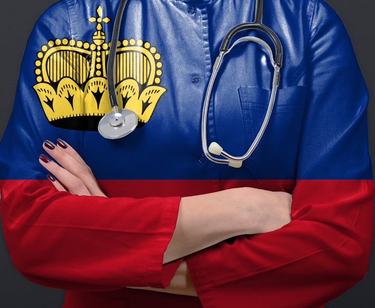 A medical professional standing confidently with folded arms, wearing a stethoscope and a uniform st