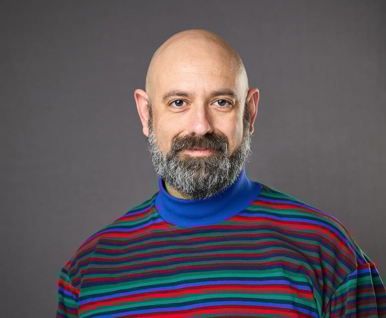 bald psychologist in striped shirt who provides therapy trauma LGBTQIA+ 