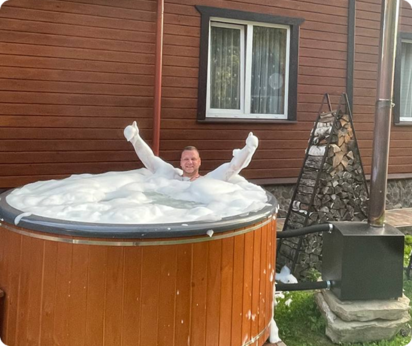 a man in a hot tub with foam foams