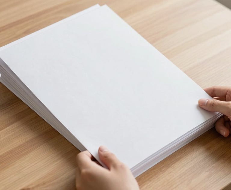 A high-angle minimalist shot of hands organizing clean white folders on a warm wooden desk, soft natural morning light, 50mm lens