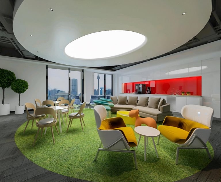 Creative lounge/breakout area — green artificial grass carpet, colourful seating (yellow, beige), ro