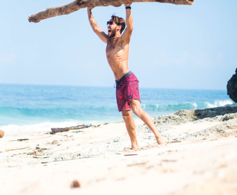 a strong man lifting a large heavy piece of wood in his hands