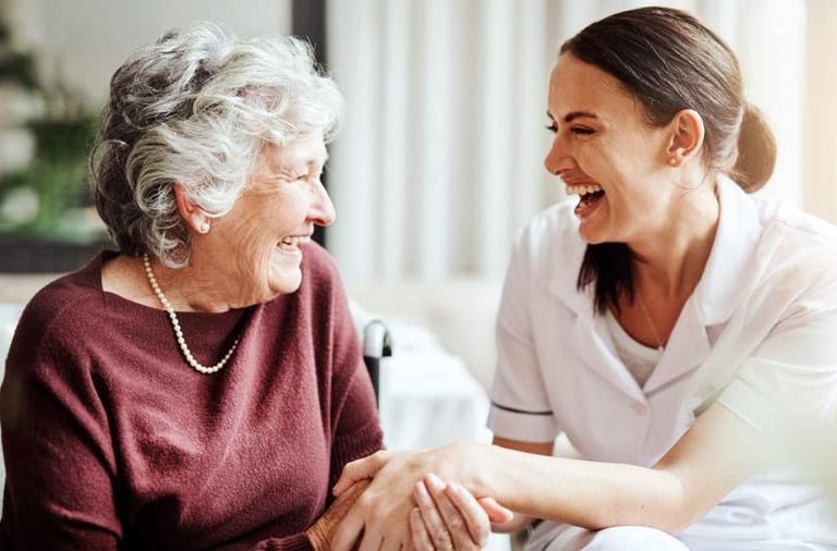 nurse and elderly woman holding hands