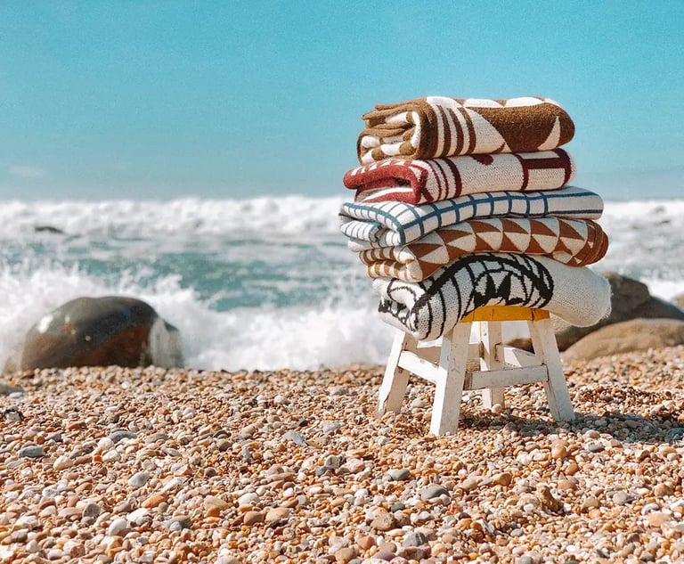 a stack of blankets on a beach
