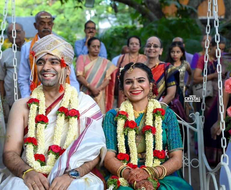 Couples sitting on oonjal on Brahmin wedding