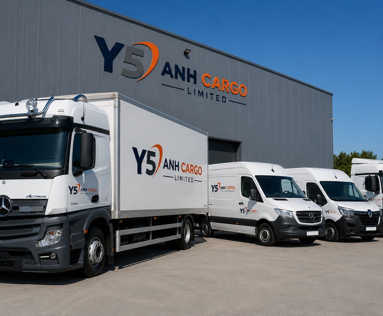 A fleet of Y5 Anh Cargo logistics trucks and delivery vans parked outside a distribution warehouse.