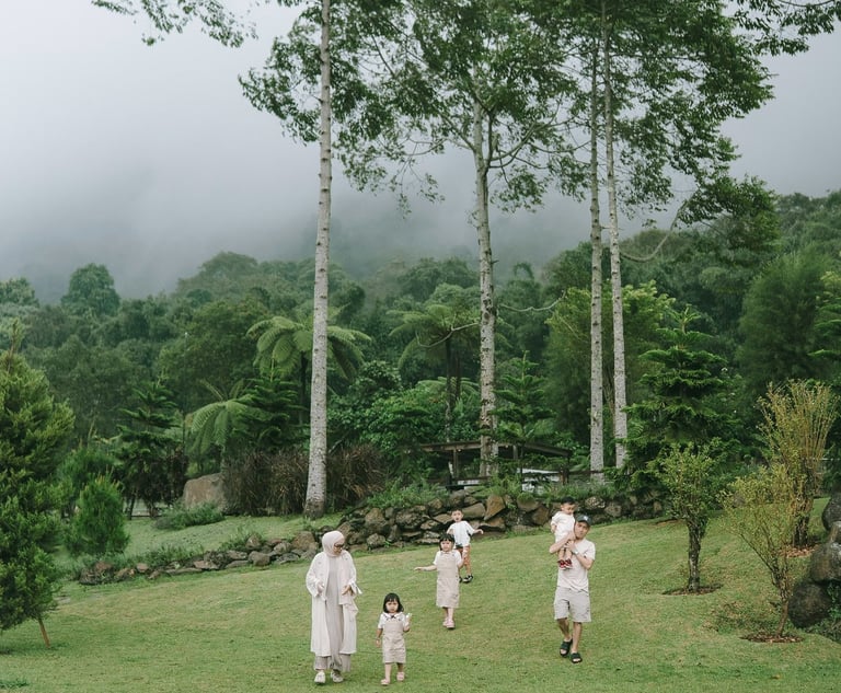 Children playing in open field during a family photography session at Bali Farm House Bedugul Bali.