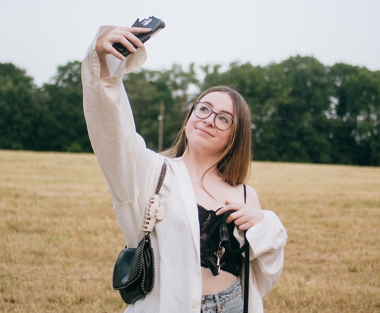 a woman taking a selfie with her cell phone