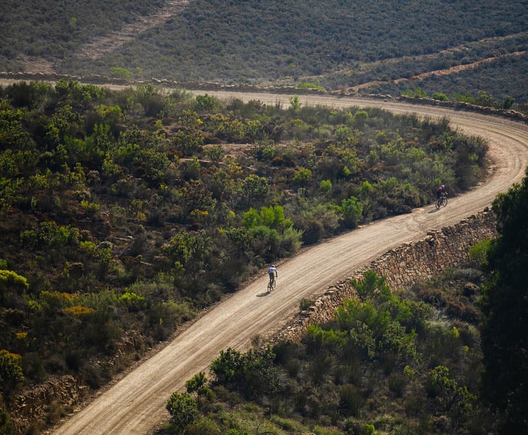 Cyclists riding mountain bikes on gravel road competition after having a cycling coach