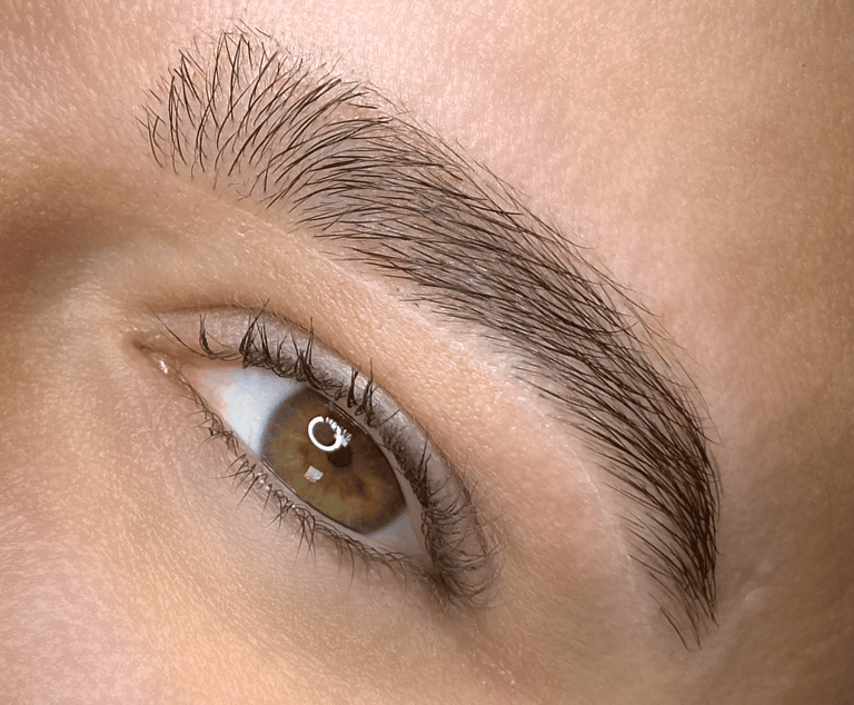 a woman with a white eye and brown eyes eyebrow design