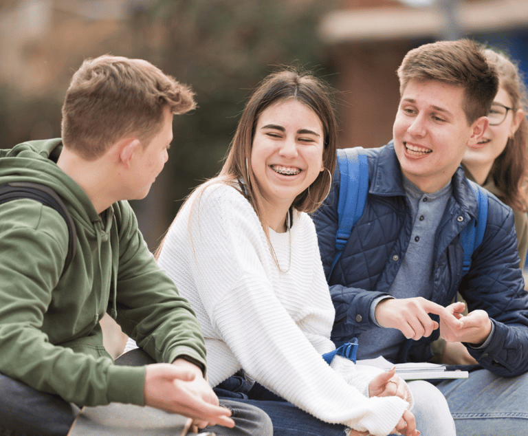 a group of young people sitting on a bench