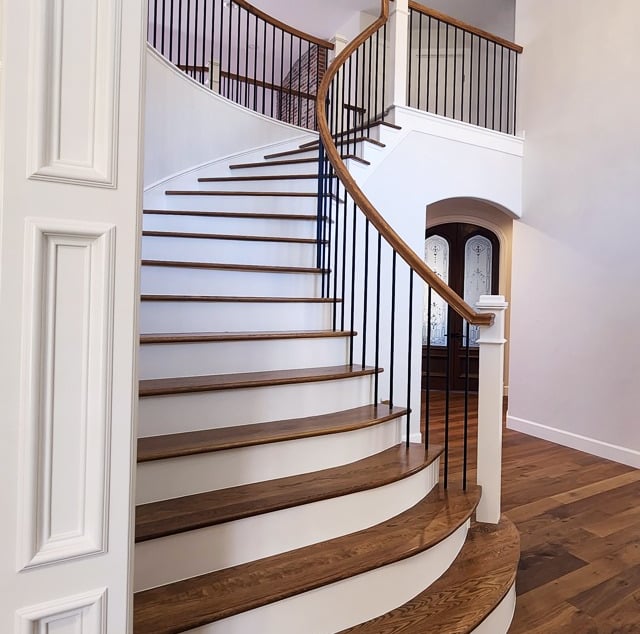 a staircase leading to a foyer with a chandelier - Denver Luxury Home Painting